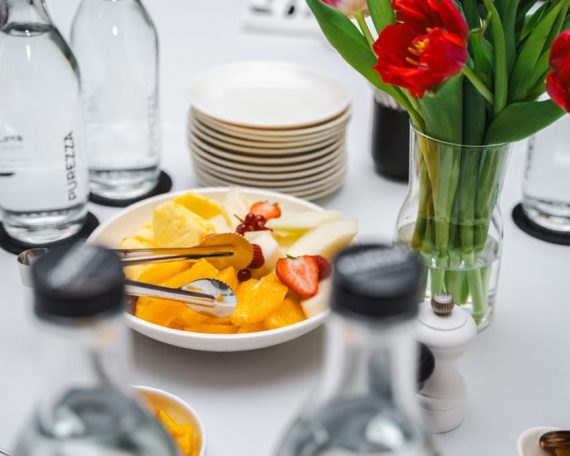 An elegant dining setup featuring fresh fruits and vibrant tulips, perfect for a healthy meal.